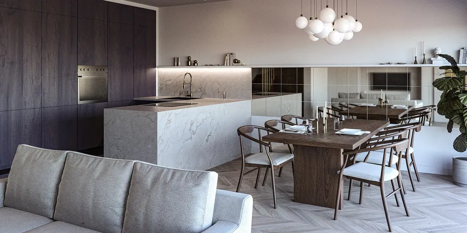 Open plan kitchen, living, and dining room with a light stone peninsula, dark wood cabinets, and mirrors on the wall.