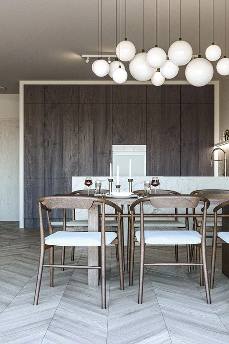 Stylish kitchen and dining room with light stone peninsula, dark wood cabinets, and mirrors across the wall.