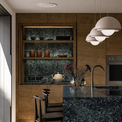 Green marble kitchen island, warm wooden cabinets, and white pendant lights in a kitchen cabinet interior.