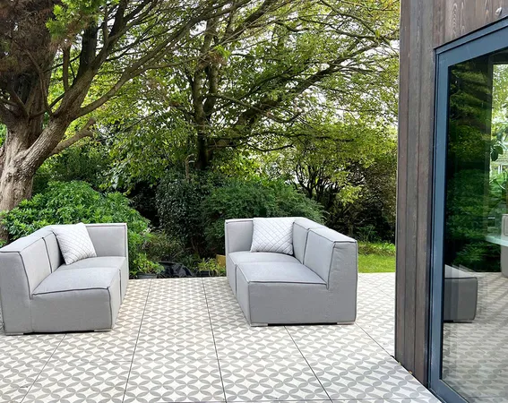 A beautiful external patio space with 2 comfortable sofas next to the timber cladded kitchen extension. This is one of the completed projects done by Skala Studio.