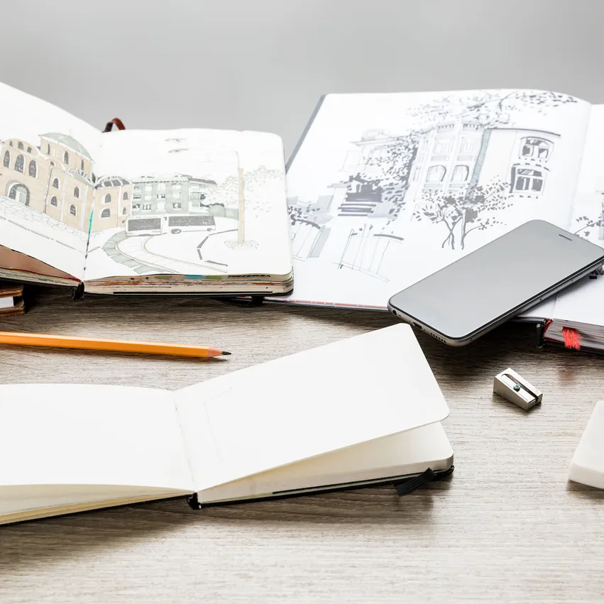 Sketchbooks showing drawings of buildings.